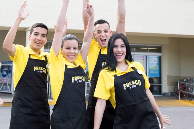 Group of Fresco y Más associates smiling and cheering. 