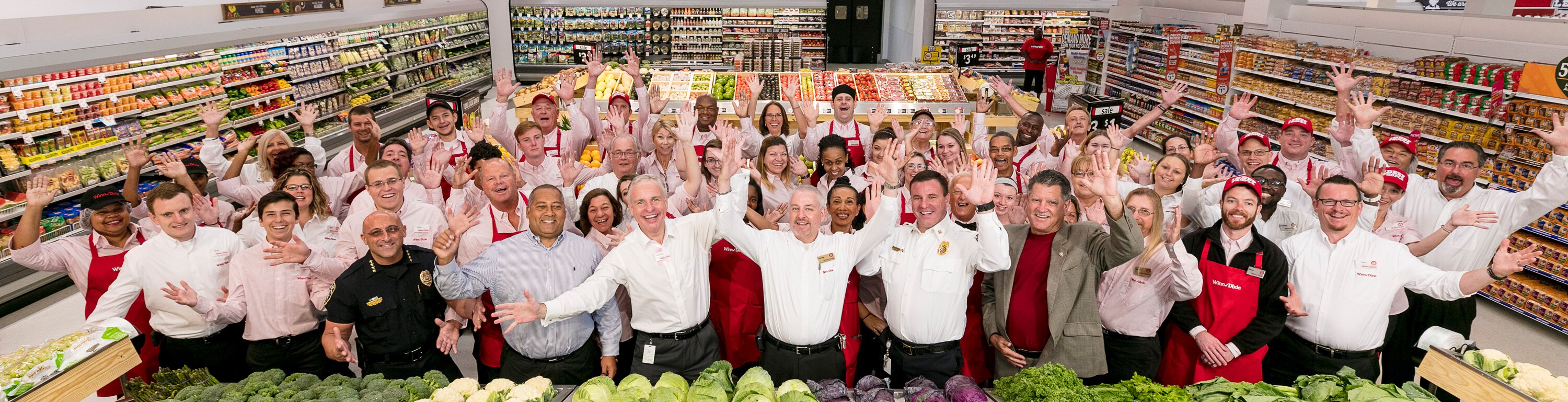 Group of Winn-Dixie Associates cheering at a grand opening.