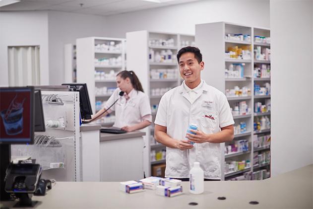 Winn-Dixie Pharmacy Associate smiling helping a customer.
