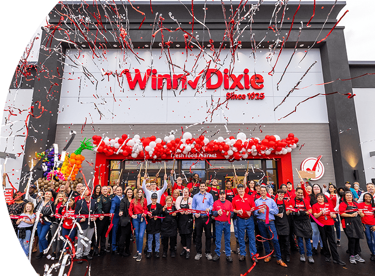Crowd of people cheering and celebrating on the storefront of the Winn-Dixie at Grand Cypress neighborhood in St. Johns County, Jacksonville.