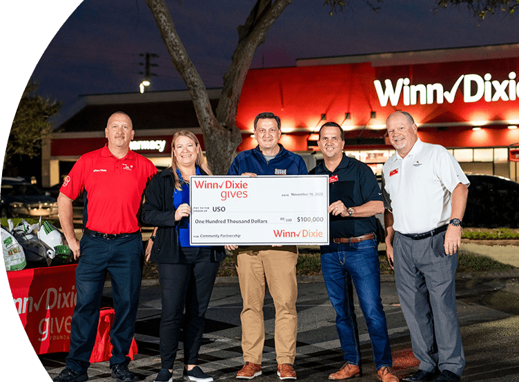 SEG and USO members holding a large-sized $100,000 check.