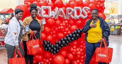 Winn-Dixie employees smiling with bags of groceries