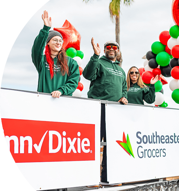 Participants at the Dr. Martin Luther King, Jr. Memorial Foundation Holiday Grand Parade joyfully smiling and waving.