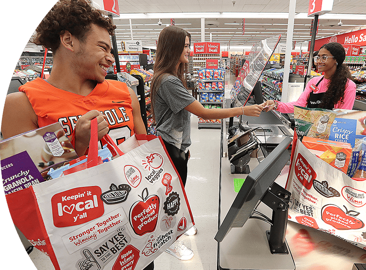 A female and male customer checking out at a Winn-Dixie. 
