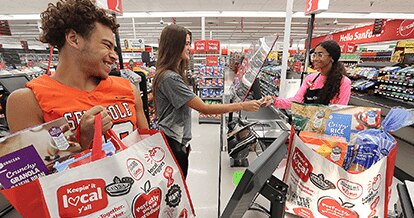 A female and male customer checking out at a Winn-Dixie. 