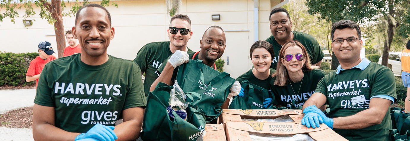 Group of Gives Foundation volunteers smiling.