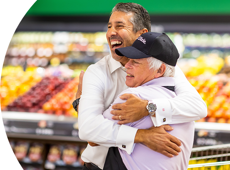 Two Winn-Dixie employees hugging and smiling