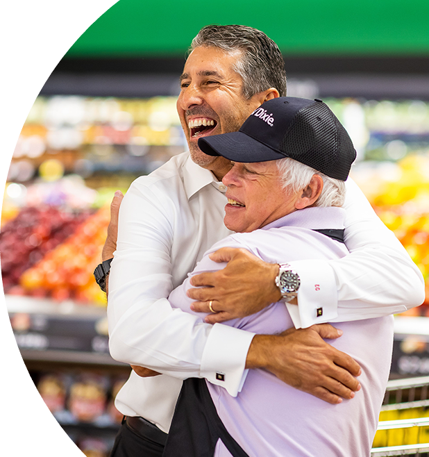 Two Winn-Dixie employees hugging and smiling