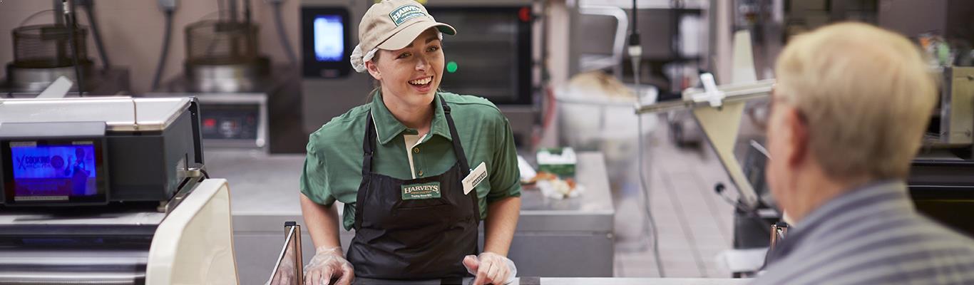 Harveys Supermarket Deli Associate helping a customer.