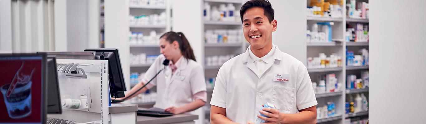 Winn-Dixie pharmacy associate helping a customer.