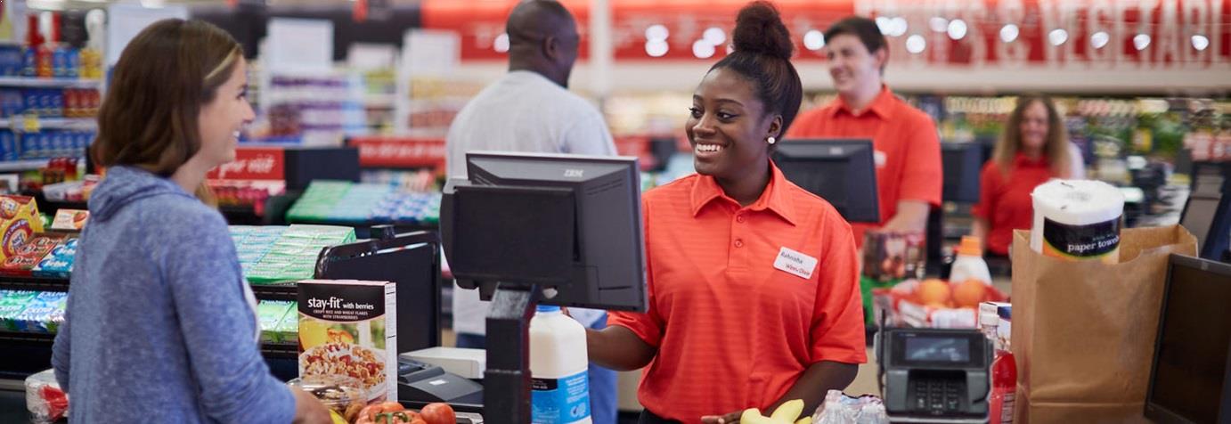 Winn-Dixie associate helping a customer at the register.